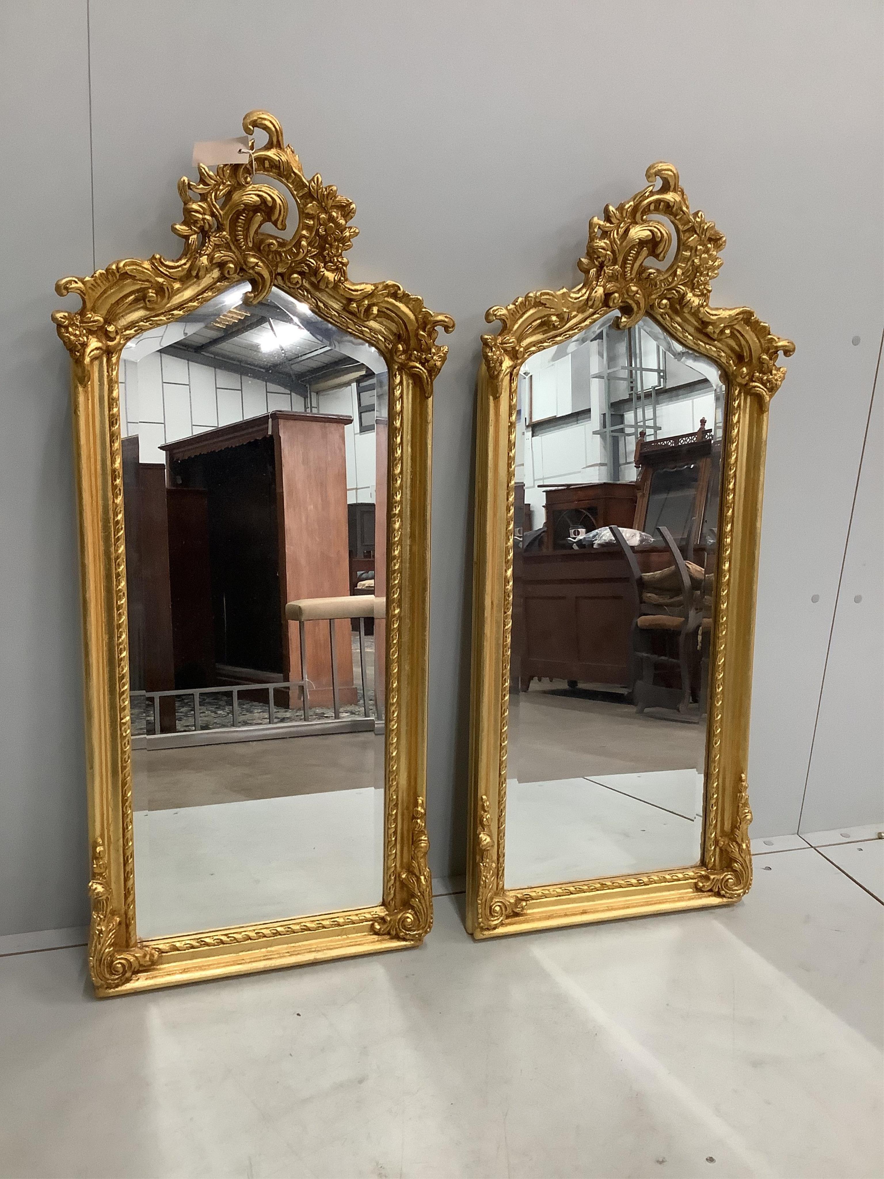 A pair of Victorian style giltwood and composition wall mirrors, width 50cm, height 113cm